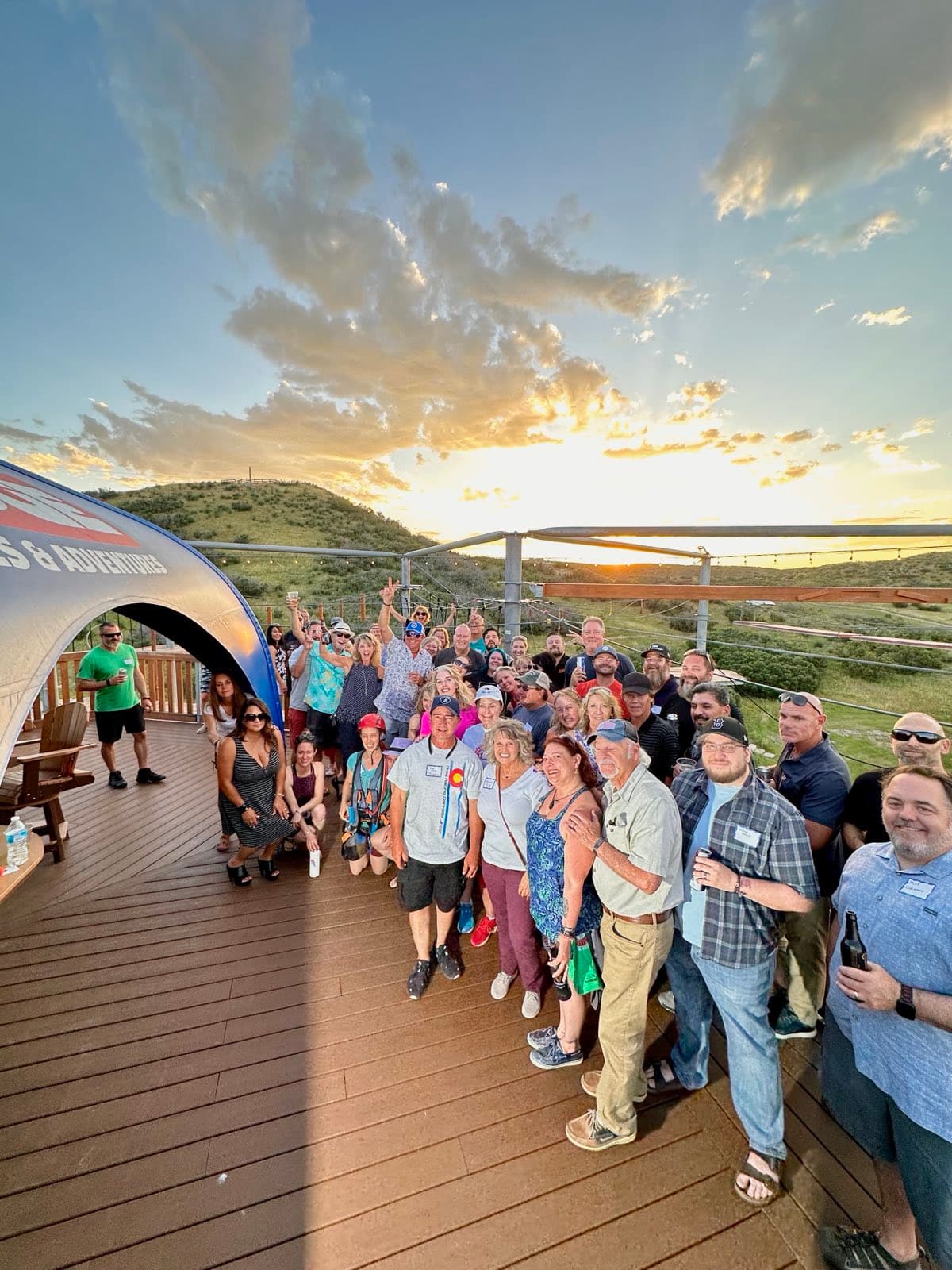 A large group gathered on the Sky Trek top deck at sunset during an evening event at The EDGE